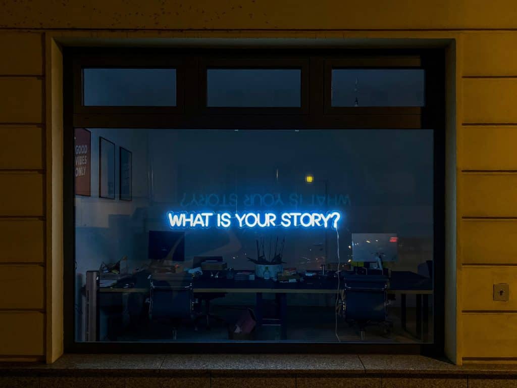 What is your story? neon sign in window