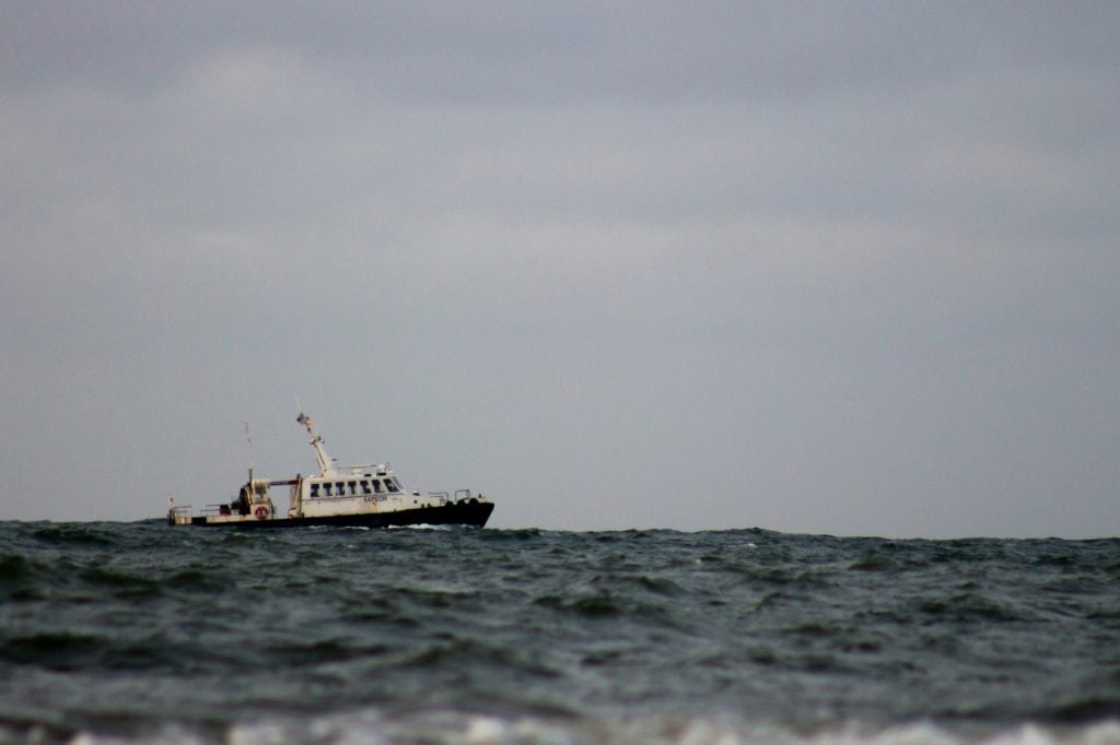 Fishing boat in rough waters on the ocean